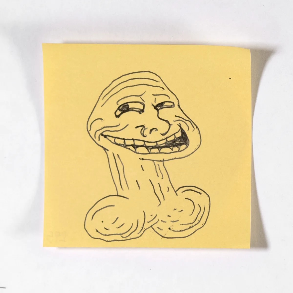 Trollface, No. 295 of 512: a hand-drawn cazzo on a sticky note